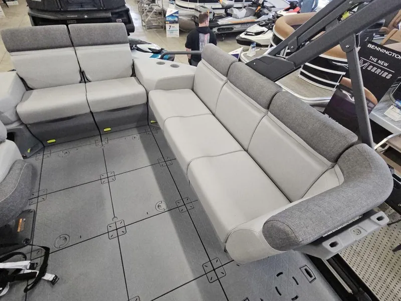 Slide: The Image of 2023 Sea-Doo Switch Sport 18-230 hp boat interior with gray seating and spacious layout. - 5