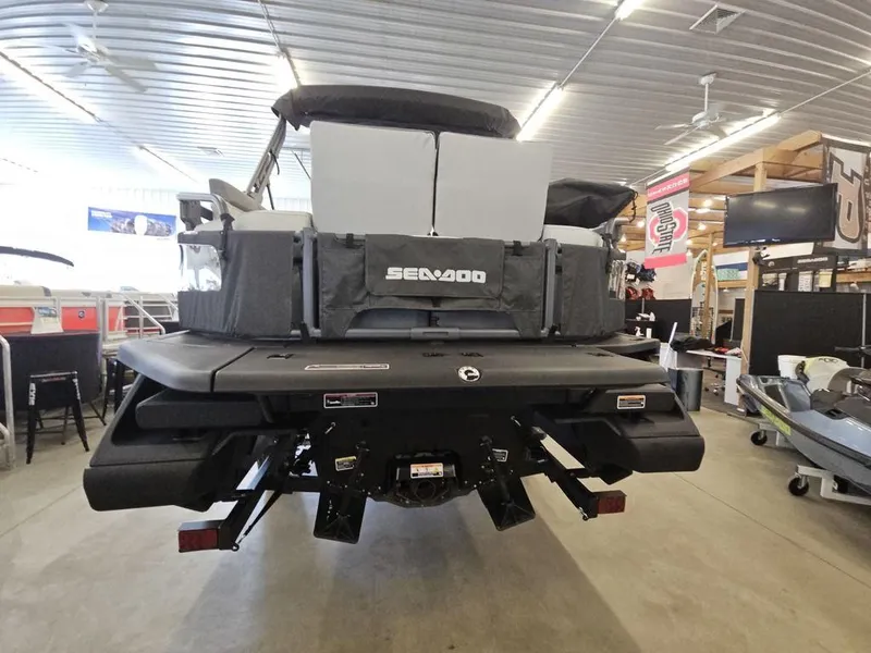 Slide: The Image of 2023 Sea-Doo Switch Sport 18-230 hp boat displayed in a showroom. - 9