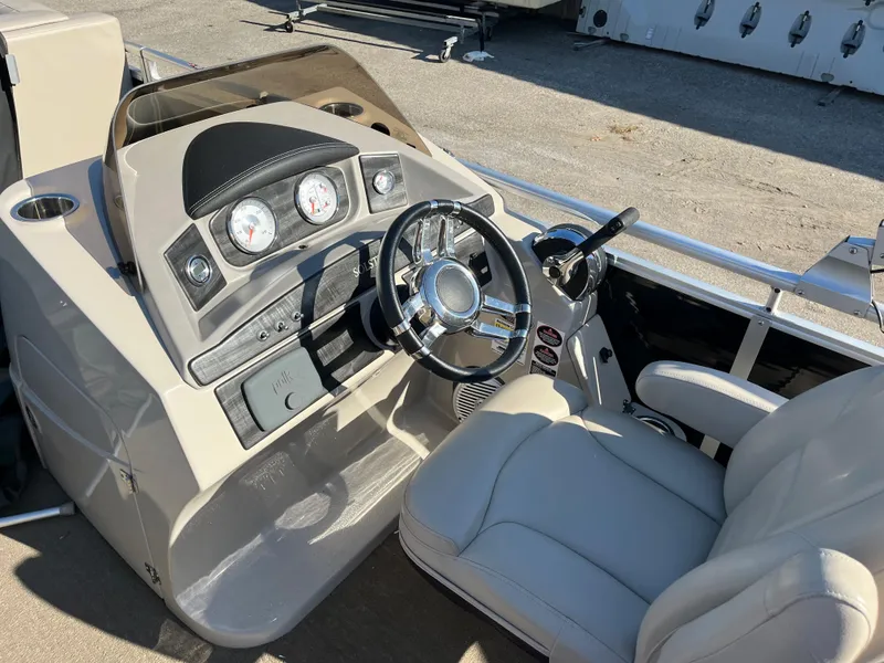 Slide: The Image of 2016 Harris Solstice 240 boat cockpit with steering wheel and gauges. - 8