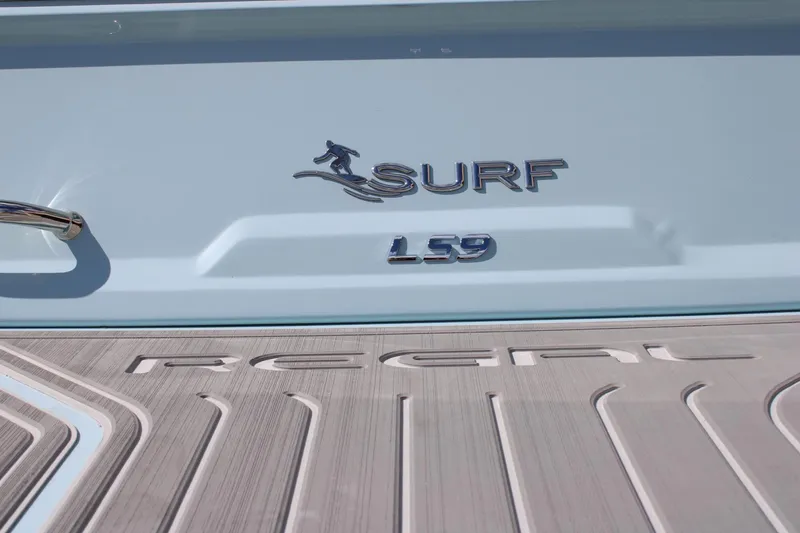 Slide: The Image of 2024 Regal LS9 Surf boat logo and branding on the deck. - 10