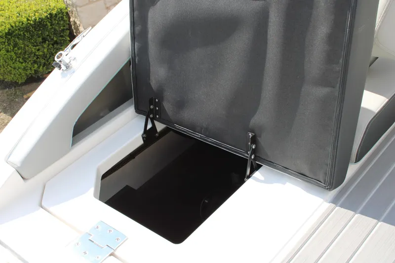 Slide: The Image of Open storage compartment on a 2024 Regal LS9 Surf boat. - 16