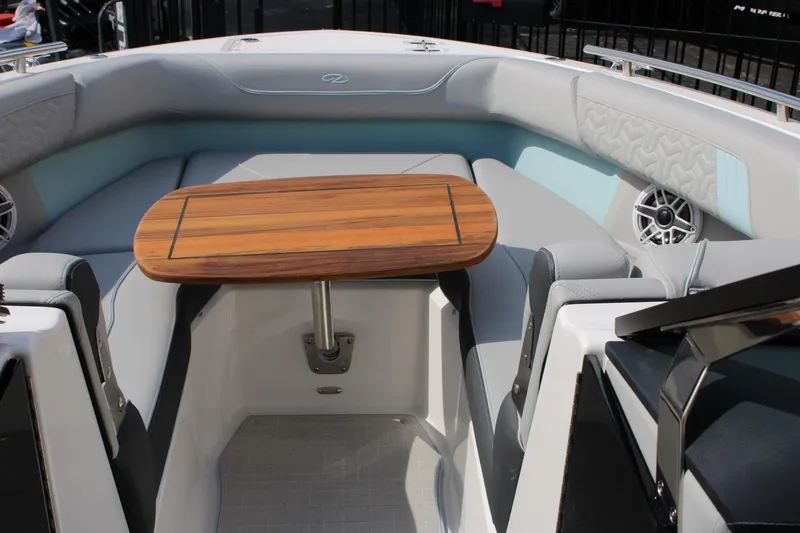 Slide: The Image of 2024 Regal LS9 Surf boat interior with wooden table and cushioned seating. - 21