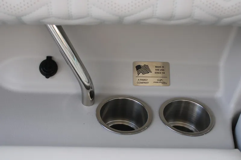 Slide: The Image of 2024 Regal LS9 Surf boat interior with cup holders and Made in the USA plaque. - 22