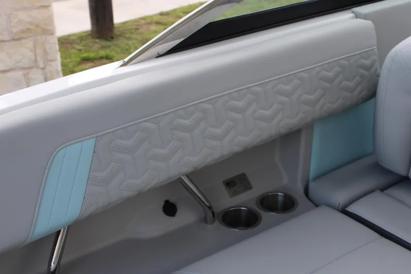 Slide: The Image of 2024 Regal LS9 Surf boat interior with quilted upholstery and cup holders. - 24
