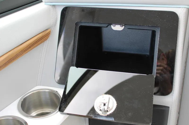 Slide: The Image of 2024 Regal LS9 Surf boat interior storage compartment with cup holders. - 29