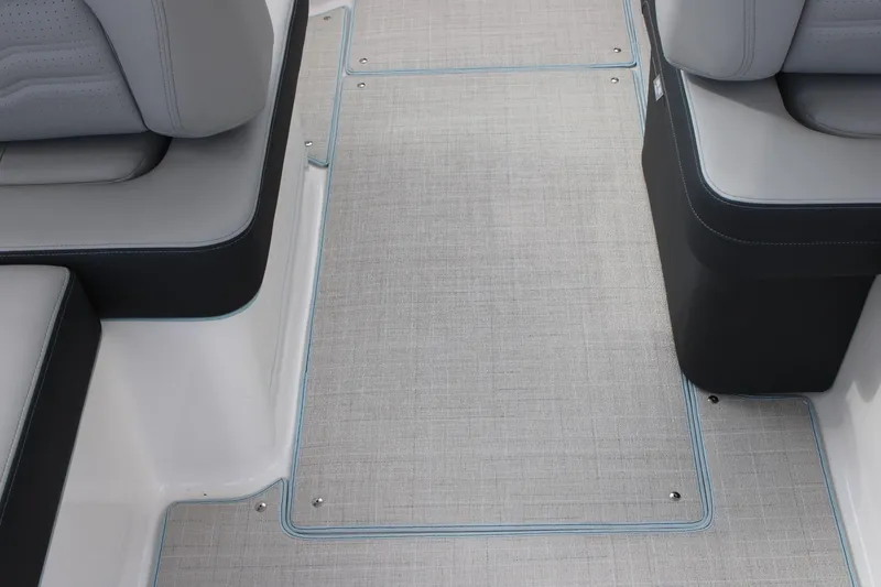 Slide: The Image of 2024 Regal LS9 Surf boat interior with grey seating and textured flooring. - 33
