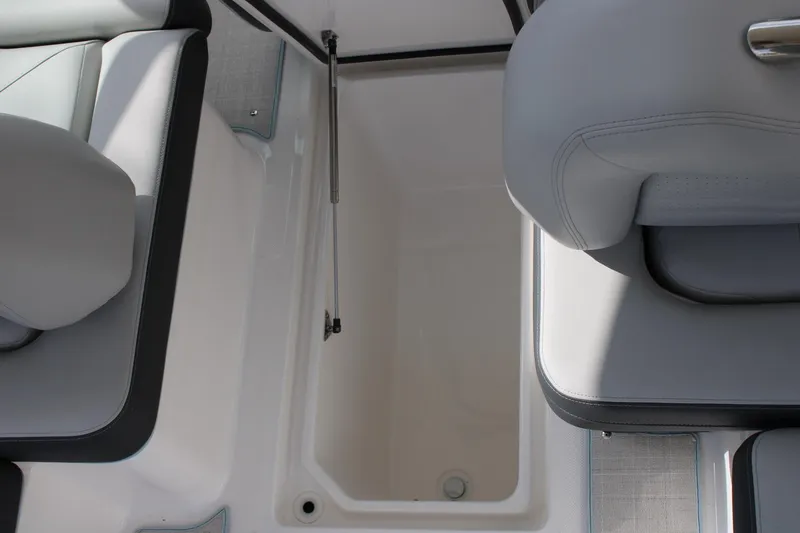 Slide: The Image of 2024 Regal LS9 Surf boat storage compartment with cushioned seating. - 34