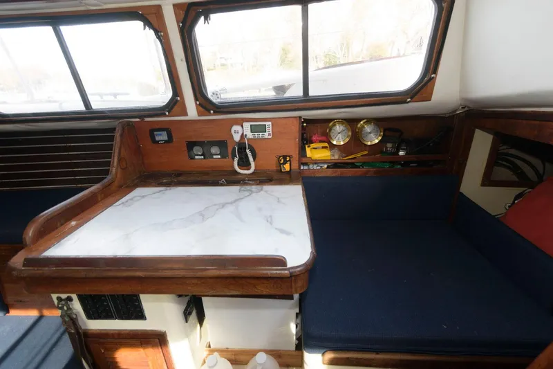 Slide: The Image of 1976 Downeast 38 boat interior with navigation station and seating area. - 10
