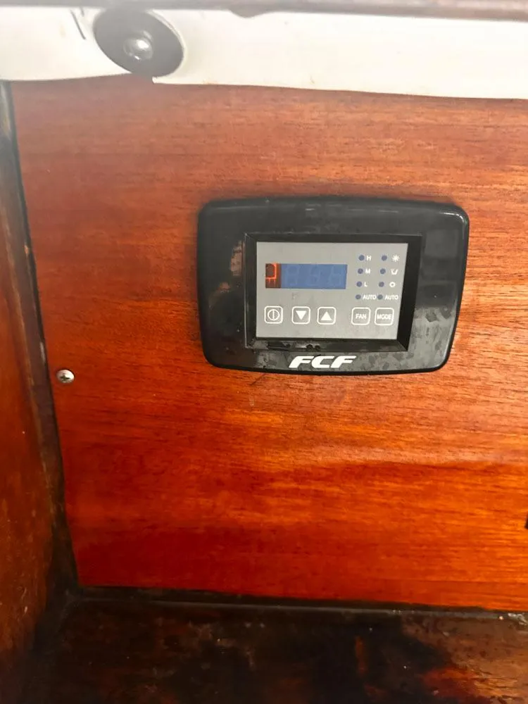 Slide: The Image of Control panel on a 1976 Downeast 38 boat with wooden interior. - 20