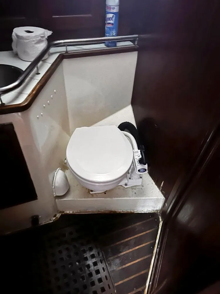 Slide: The Image of 1976 Downeast 38 boat bathroom with marine toilet and sink. - 23