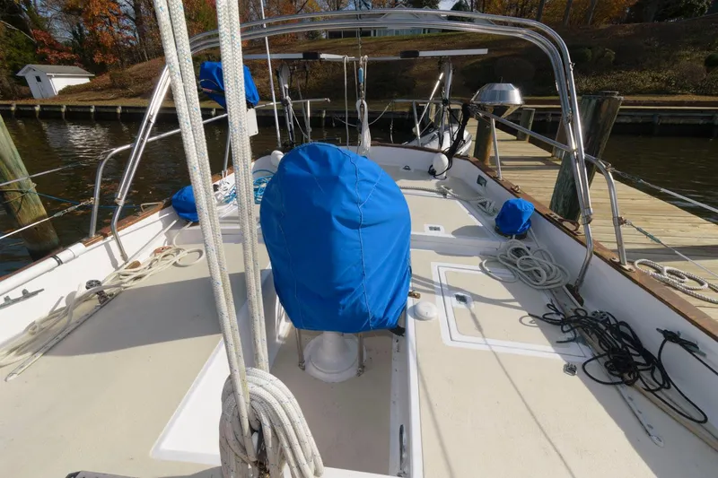 Slide: The Image of 1976 Downeast 38 sailboat deck with blue covers and docked at marina. - 5