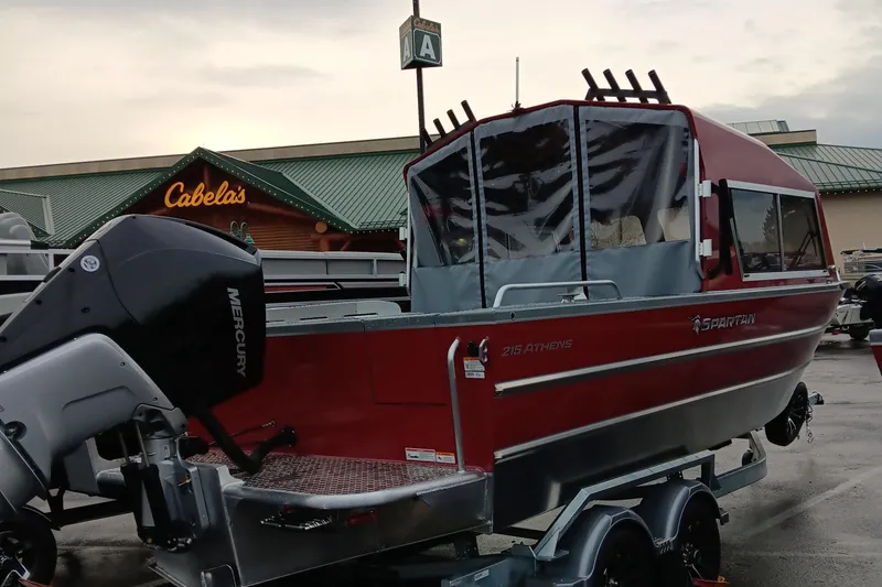 Slide: The Image of 2024 Spartan 215 Athens boat with Mercury outboard motor at Cabela's parking lot. - 3