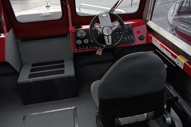 Slide: The Image of 2024 Spartan 215 Athens boat interior with steering wheel and control panel. - 5