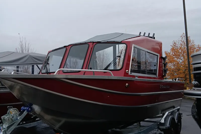 Slide: The Image of 2024 Spartan 215 Athens boat in red, parked on a trailer. - 6