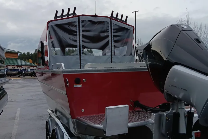 Slide: The Image of 2024 Spartan 215 Athens boat with outboard motor in parking lot. - 8