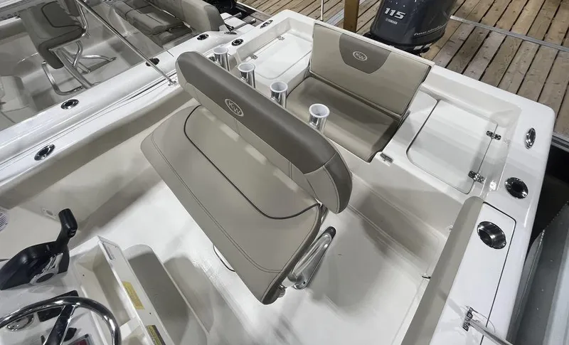 Slide: The Image of 2024 Key West 179 FS boat interior with beige seating and cup holders. - 2