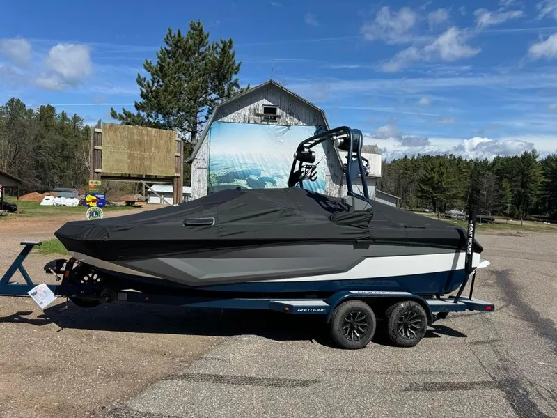 Slide: The Image of 2024 Nautique Super Air GS20 boat on trailer with cover, parked outdoors. - 3