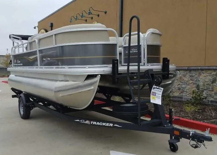 Slide: The Image of 2024 Sun Tracker Party Barge 18 DLX pontoon boat on a trailer. - 2