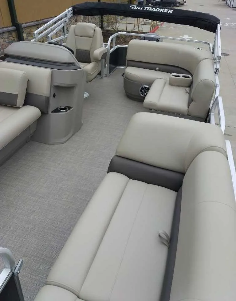 Slide: The Image of 2024 Sun Tracker Party Barge 18 DLX interior with spacious seating and modern design. - 7