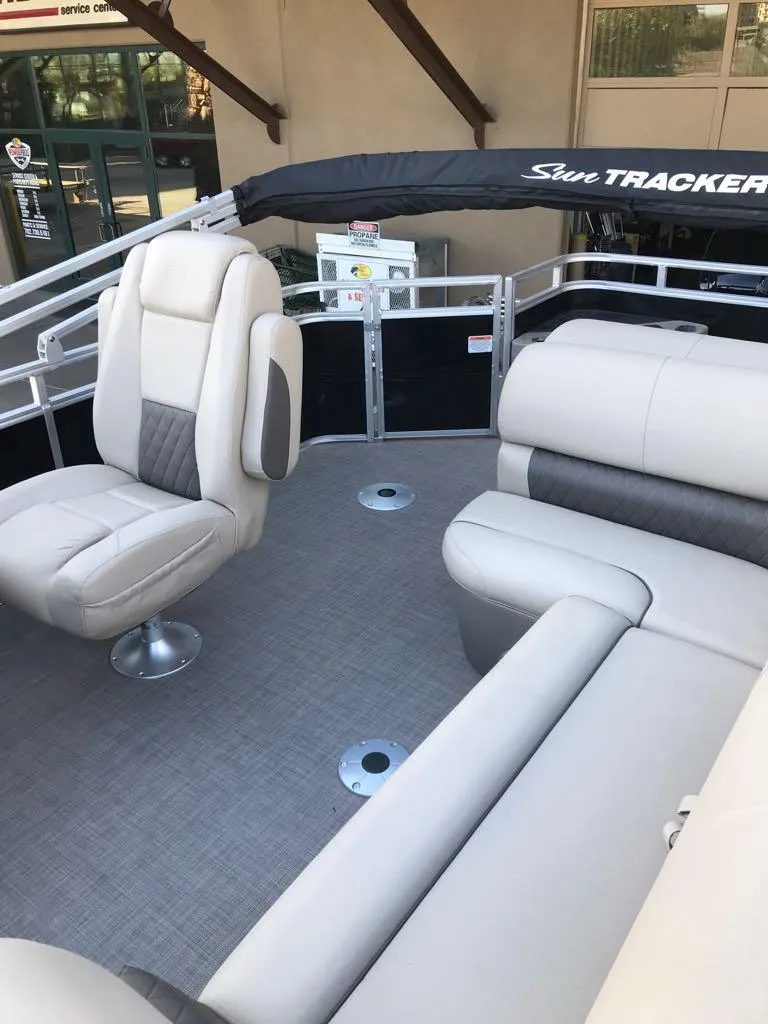 Slide: The Image of 2024 Sun Tracker SportFish 20 DLX pontoon boat interior with plush seating. - 10