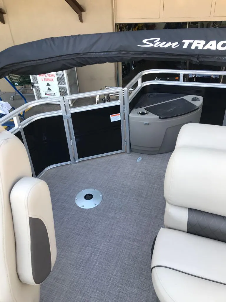 Slide: The Image of 2024 Sun Tracker SportFish 20 DLX pontoon boat interior with seating and railing. - 12