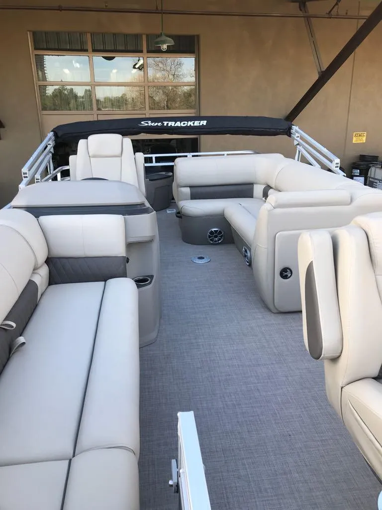 Slide: The Image of 2024 Sun Tracker SportFish 20 DLX pontoon boat with spacious seating and modern design. - 14