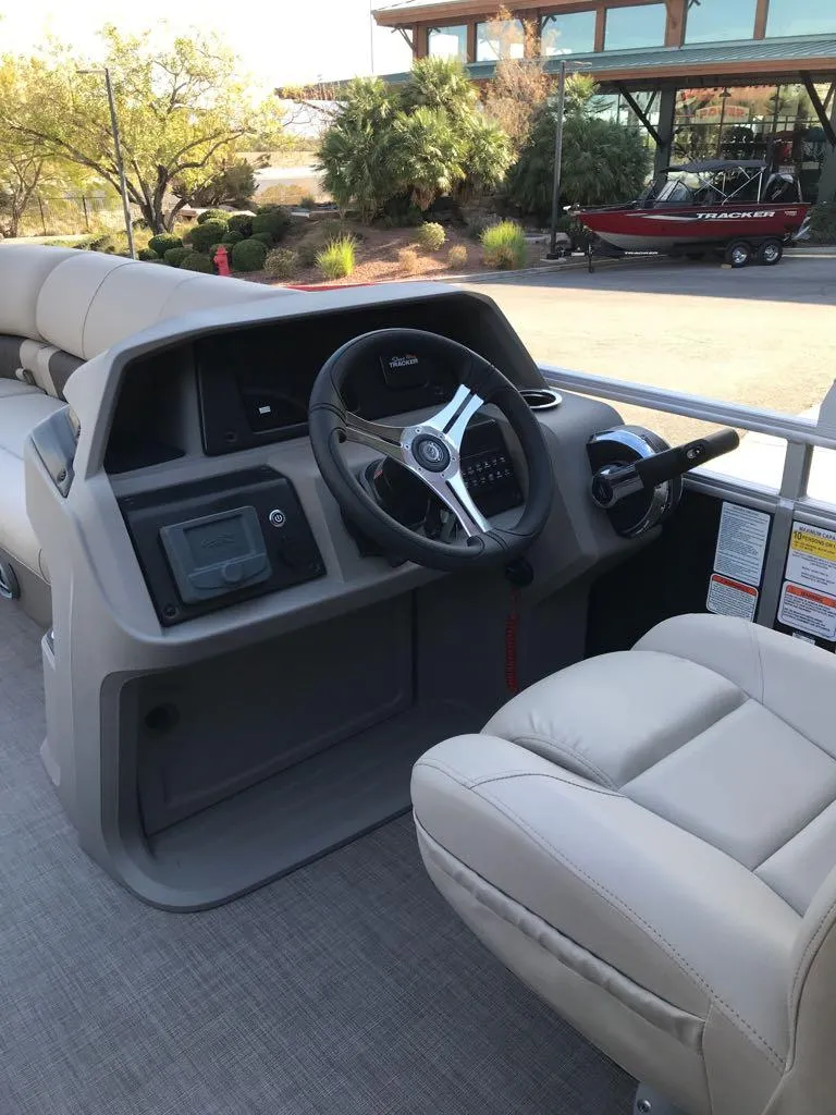 Slide: The Image of 2024 Sun Tracker SportFish 20 DLX boat interior with steering wheel and dashboard. - 5