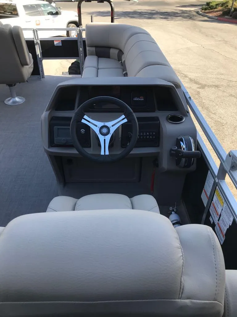 Slide: The Image of 2024 Sun Tracker SportFish 20 DLX boat interior with steering wheel and seating. - 6