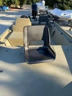 Slide: The Image of 2024 Tracker Grizzly 1754 SC boat with black seat, outdoor setting. - 2