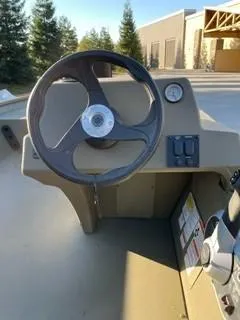 Slide: The Image of 2024 Tracker Grizzly 1754 SC boat steering console with control panel and gauge. - 3