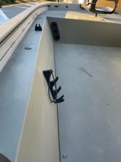 Slide: The Image of 2024 Tracker Grizzly 1754 SC boat interior with rod holders and seating area. - 4