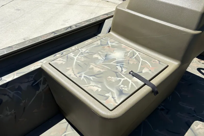 Slide: The Image of 2024 Tracker Grizzly 1754 SC boat seat with camouflage pattern and storage compartment. - 18