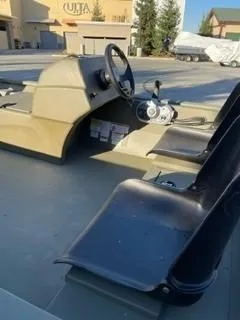 Slide: The Image of 2024 Tracker Grizzly 1754 SC boat interior with steering console and seating. - 5