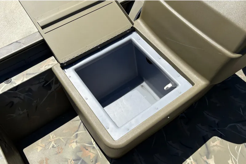 Slide: The Image of 2024 Tracker Grizzly 1754 SC boat storage compartment with open lid, showcasing interior space. - 19