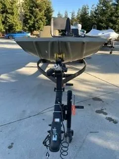 Slide: The Image of 2024 Tracker Grizzly 1754 SC boat on trailer, outdoor setting. - 6