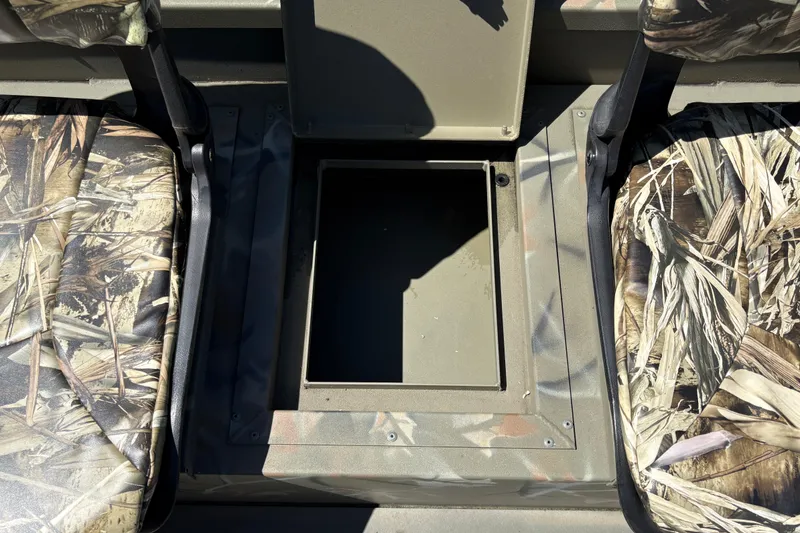 Slide: The Image of 2024 Tracker Grizzly 1754 SC boat interior with camo seats and storage compartment. - 23