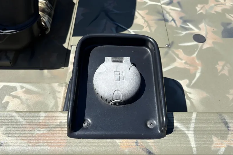 Slide: The Image of 2024 Tracker Grizzly 1754 SC boat fuel cap on camouflage deck. - 27