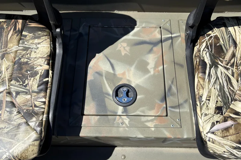 Slide: The Image of 2024 Tracker Grizzly 1754 SC boat interior with camouflage seats and storage compartment. - 24