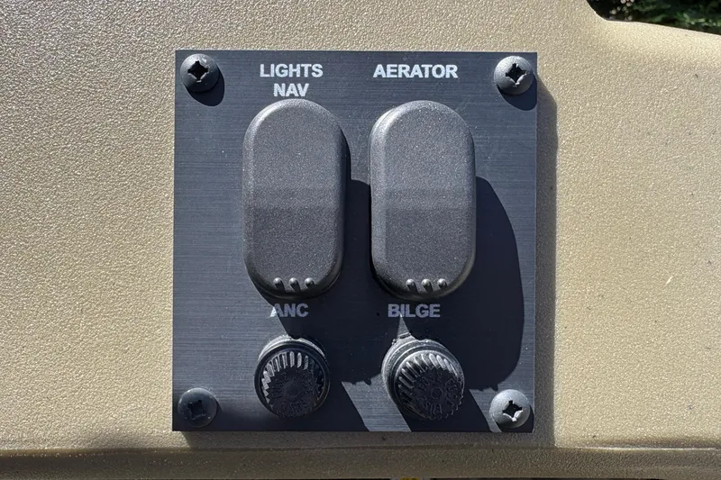 Slide: The Image of Control panel of 2024 Tracker Grizzly 1754 SC boat with switches for lights, aerator, and bilge. - 28