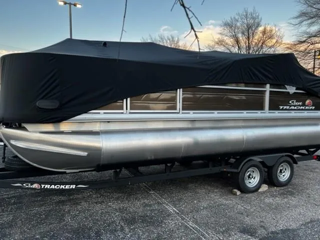 The Image of 2024 Sun Tracker SportFish 20 DLX pontoon boat on trailer, side view. - 0
