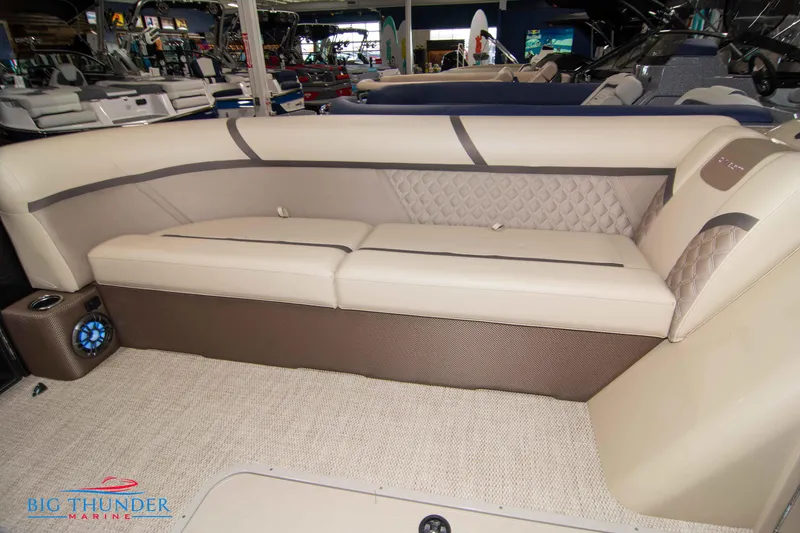 Slide: The Image of 2023 Crest Classic DLX 240 SLC boat interior with beige seating and carpet. - 10