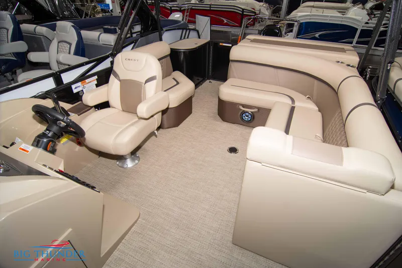Slide: The Image of 2023 Crest Classic DLX 240 SLC pontoon boat interior with beige seating. - 23