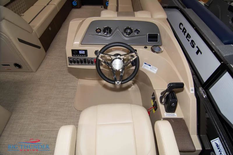 Slide: The Image of 2023 Crest Classic DLX 240 SLC boat interior with steering wheel and control panel. - 24
