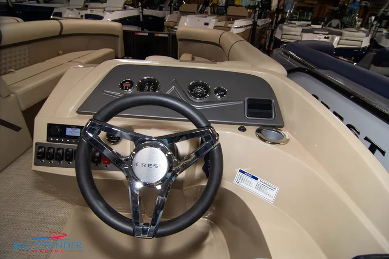 Slide: The Image of 2023 Crest Classic DLX 240 SLC boat dashboard with steering wheel and controls. - 26