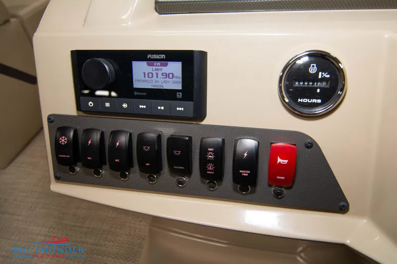 Slide: The Image of Control panel of 2023 Crest Classic DLX 240 SLC boat with switches and Fusion stereo. - 29