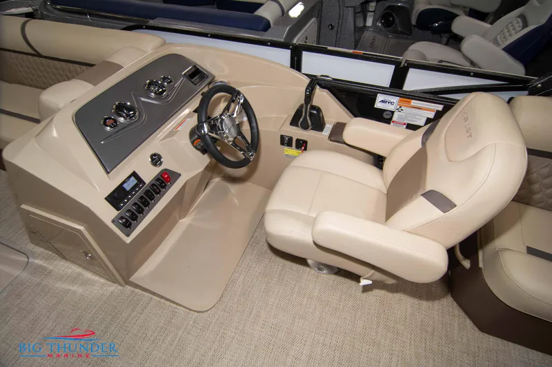 Slide: The Image of 2023 Crest Classic DLX 240 SLC boat helm with beige captain's chair and control panel. - 31