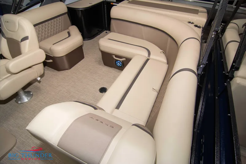 Slide: The Image of 2023 Crest Classic DLX 240 SLC boat interior with beige and brown seating. - 33