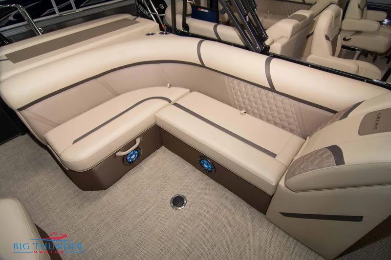 Slide: The Image of 2023 Crest Classic DLX 240 SLC boat interior with luxurious beige seating. - 34
