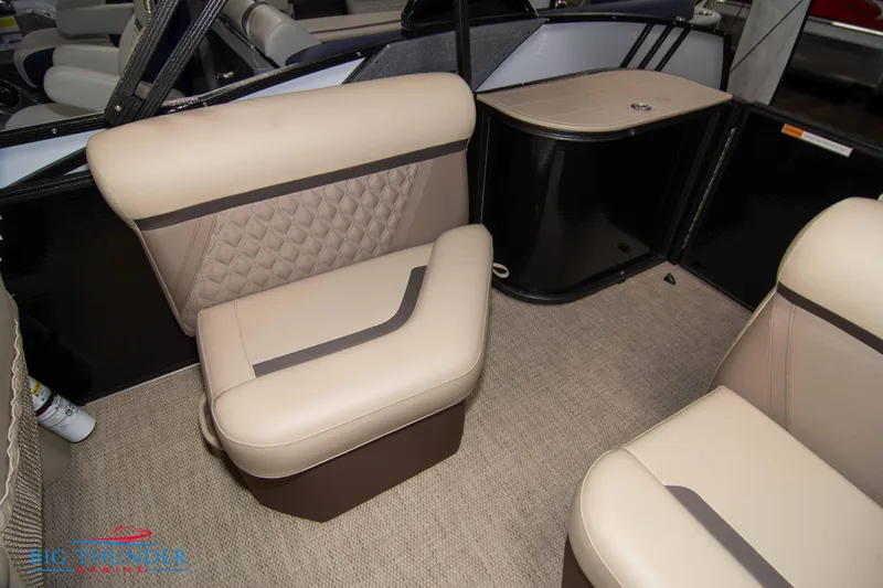 Slide: The Image of 2023 Crest Classic DLX 240 SLC boat interior with beige seating and carpet. - 35