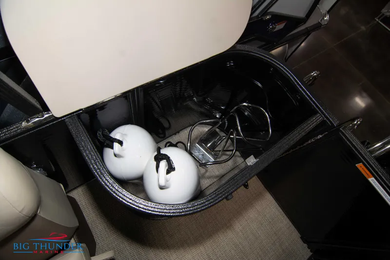 Slide: The Image of Storage compartment of 2023 Crest Classic DLX 240 SLC boat with helmets and accessories. - 36